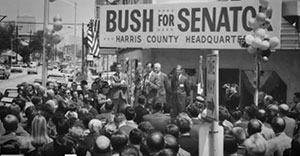 Crowd of people under Bush for Senator sign