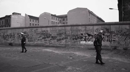Two soldiers guarding the Berlin Wall