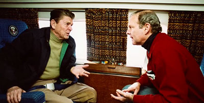 Baker and President Ronald Reagan seated talking