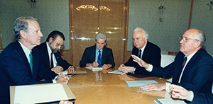 Baker with Gorbachev and other Soviet leaders seated at table