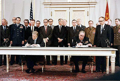 President Carter and Soviet leader Breshnev sitting at table